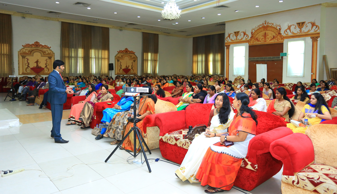 naseer khan inspiring a large audience of women during transformation session